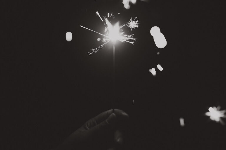 Black and white of a lit sparkler. Learn to write with sparklers & photograph it!  