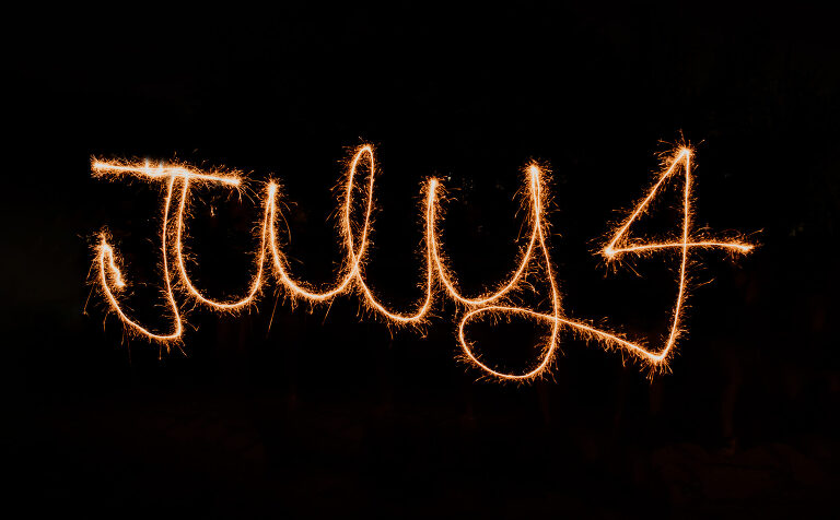 July 4 written with a sparkler. Learn to write with sparklers & photograph it!  