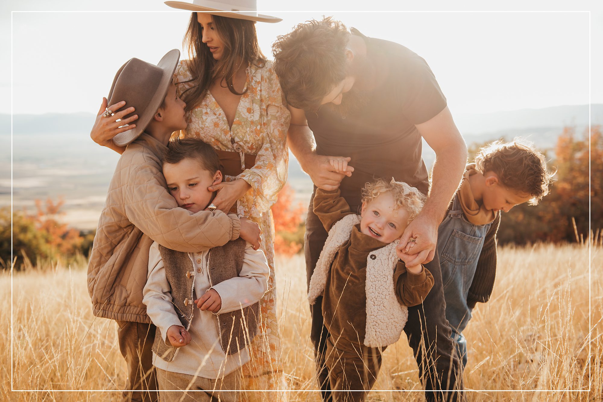 Family of six sharing a joyful moment during a golden hour photo session in Utah, capturing the love and connection between parents and children.